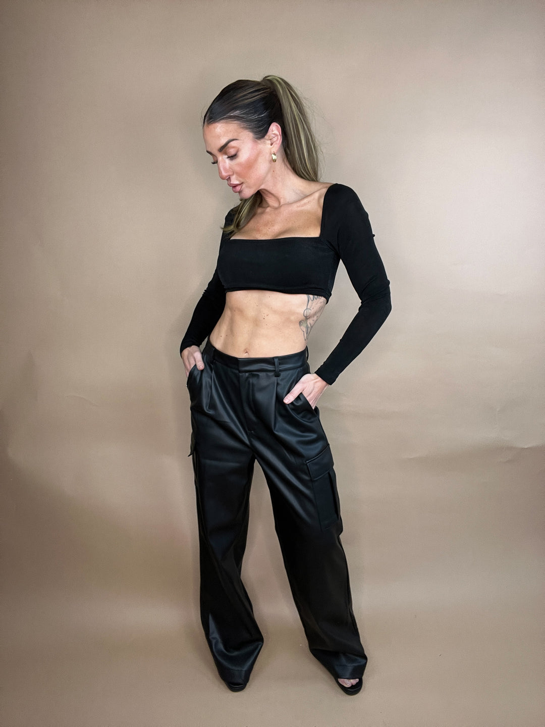 faux leather cargo pants in mid rise fit with relaxed wide leg 